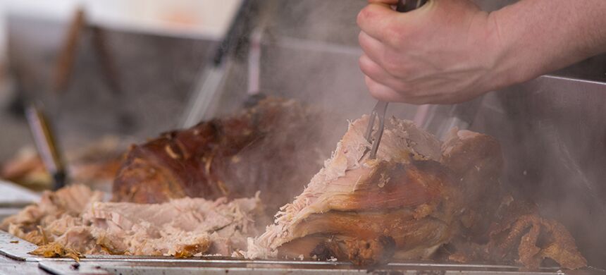 A whole roast pig being carved